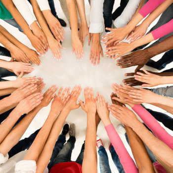 Group of people showing hands together in a circle