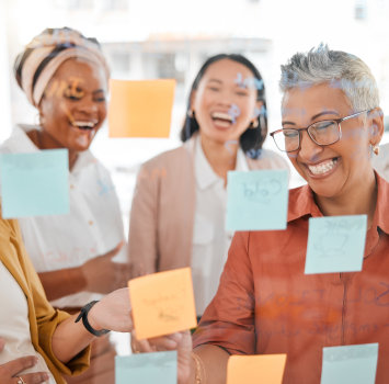 A group of women with post-it notes flying around them
